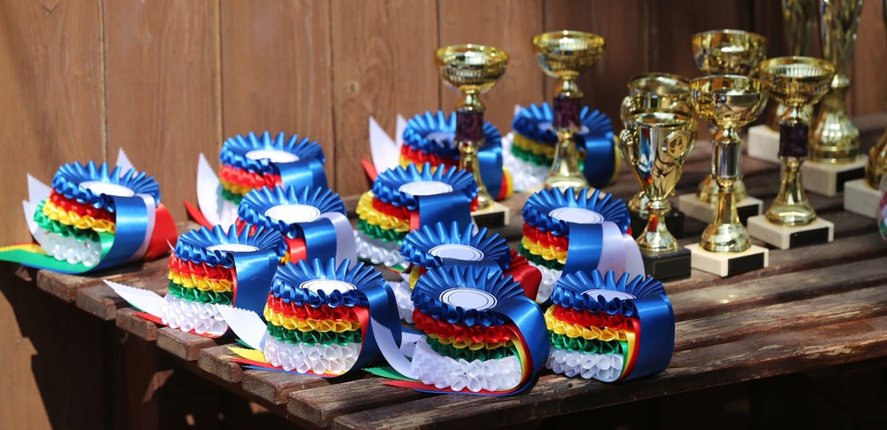 Equestrian athletes are rewarded with rosettes and trophies